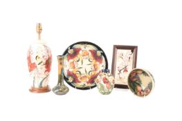 A collection of Moorcroft pieces comprising a table lamp in the Family through Flowers pattern, a Ch