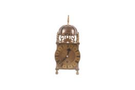 A reproduction brass Lantern clock, fitted bell strike to top, the chapter ring with Roman numerals 