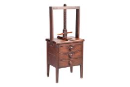 A 19th-century oak bookbinder's press with a large threaded wooden bar with turned handle, above a b
