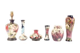 A collection of six Moorcroft pieces consisting of a tall baluster form decorated in the Provence pa