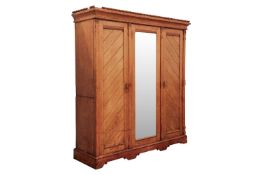 In the manner of Charles Bevan, a blonde Ash mirror door compactum wardrobe in three sections, with 