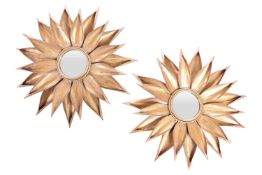 A pair of gilt and wrought brass circular wall mirrors in the form of large sunflower heads with a c