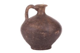 A Roman black burnished ware flagon, measuring 16 cm x 16 cm x 16 cm