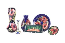 A collection of Moorcroft pieces comprising a Macintyre Florian ware pottery vase of bottle form wit