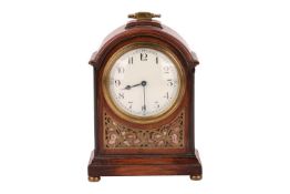 An Edwardian brass inlaid mahogany mantle clock with a broken arch case, with Arabic convex dial, an