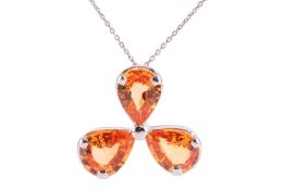 A trefoil orange sapphire pendant; the three pear-shaped orange sapphires in a claw mounted flower h