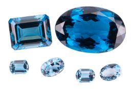 A quantity of unmounted blue topaz, including a large oval cut example weighing approximately 50 car