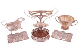 A George III silver wine coaster, pierced sides and beaded border, with turned wooden base, marks ru