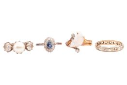 A collection of four rings to include an opal and diamond-set ring in yellow metal marked '18k', siz