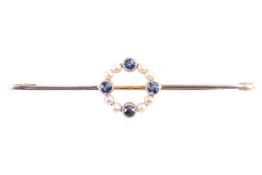 A sapphire and seed pearl bar brooch, featuring a circlet of sapphires and seed pearls, set in yello