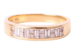 A diamond half eternity ring, set with baguette cut and princess cut diamonds in a channel setting, 