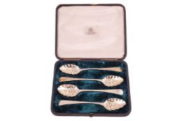 A set of four George III silver dessert spoons later decorated, the bowls with berries and gilded, i