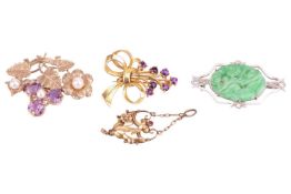 Three gem-set brooches and a pendant; to include a carved jadeite brooch, claw-set in an open-work l