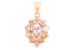 A gem-set cluster pendant, in a yellow metal mount marked '750', featuring a pear-shaped cubic zirco