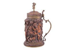 A copper copy after a 17th-century ivory tankard, representing the drunken Silenius, with a scroll h