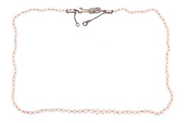 A single-row graduated cultured pearl necklace, hand-knotted with a string of cream coloured pearls 