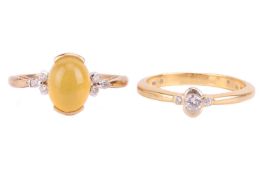 A fire opal and diamond dress ring in 9ct gold, the fire opal cabochon of orangish-yellow colour and