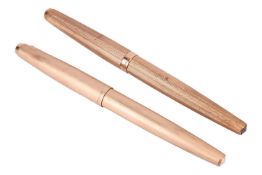 Two Parker fountain pens; including one cased in 9ct yellow gold, barrel and cap covered with engine
