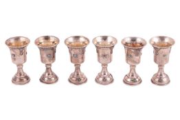 A set of six white metal kiddish cups decorated with filagree and simulated turquoise cabochons, 9.2