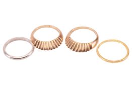 A 22ct gold wedding band in size Q½, a pair of 9ct gold scalloped design stacking rings in size P, a