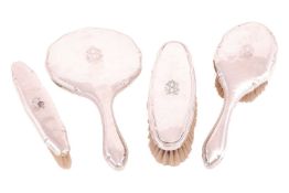 A German dressing table set, comprising a mirror, hairbrush and two clothes brushes, each with 'RS' 