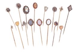 A collection of stick pins; to include examples of a gem-set fly motif, an oval scalloped head star-