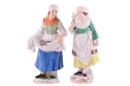 A pair of Herend porcelain figures, a Fisherwoman and an Oysterwoman, the tallest measuring 24 cm