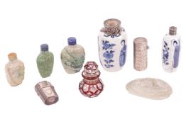 A collection of small items comprising three carved jadeite snuff bottles, a hand-carved figure of Q
