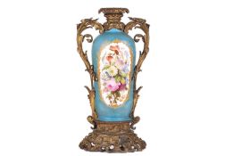 A 19th century French ormolu mounted Sevres style vase, the pale blue ground vase with a panel depic