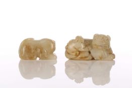 A Chinese jade temple lion, in crouching position, the jade with flecks of russet,4.5cm; and a jade 
