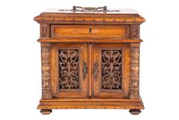 A Victorian English walnut table cabinet, with a brass swing handle above a single frieze drawer, an
