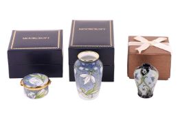 A collection of Moorcroft miniatures, comprising a Snowdrop enamel trinket box, a Snowdrop enamel va