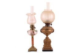 A Victorian gilt metal Duplex oil lamp, with rococo decoration in relief, fitted an acid frosted glo