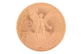 A Centenario Mexican 50 Pesos coin, the reverse depicting an eagle battling a snake enscribed Estado