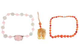 A rose quartz and fluorite necklace; a single-strand of agate beads and a jade pendant the strung ro