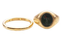 A bloodstone signet ring and a 9ct gold wedding band; collet-set with an oval-shaped bloodstone inta