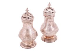 A pair of George II silver pepperettes, of baluster form, with band to belly, pierced pull-off cover