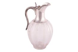 A late Victorian silver mounted cut glass claret jug, of tapering ovoid form with star cut base with