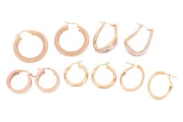 A collection of five pairs of hoop earrings; including a pair of mesh-style hoops, a pair of tri-col
