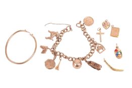 A 1960s 9ct gold charm bracelet, with a flat curb-link bracelet, missing its clasp, with thirteen in