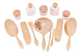 A silver gilt engine-turned dressing table set, including brushes, jars, hand mirror and shoehorn, a