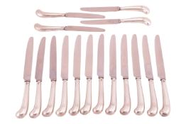 A late Victorian set of twelve silver pistol grip table knives and four dessert knives, each engrave