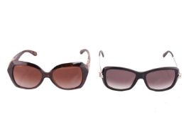 A pair of black Cartier sunglasses, the arms marked AB2148 