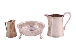 A Victorian silver bowl, of round form, overall decorated with repousse flowers and C Scrolls, with 