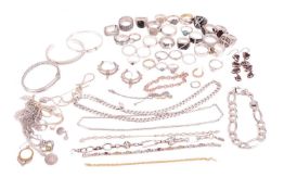 A collection of jewellery items including a curved crossover ring by Alan Crocetti ring, a patterned