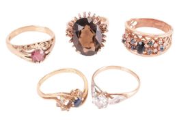 Five gem-set rings; comprising a smoky quartz cocktail ring in 9ct gold, size K; a CZ-set ring in 9c
