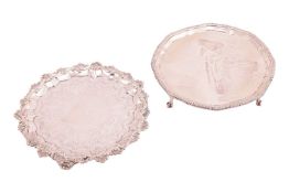 A Victorian salver with raised scroll border and flat chased to centre around a central crest (rubbe