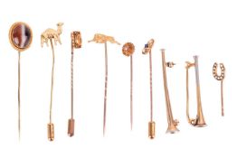 A collection of stick pins and brooches; to include a banded agate cabochon agate in yellow metal te