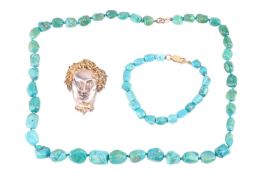 A silver sculpted Medusa head brooch with sapphire eyes and gilt hair by Albion Craft Co., brooch fi