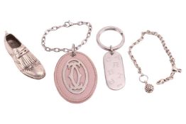 A Tiffany golf shoe key chain and two Cartier keyrings; the shoe key chain is signed and marked '925